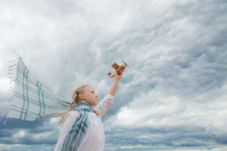 Traveling and freedom concept. Girl in White shirt and airplaneの写真素材