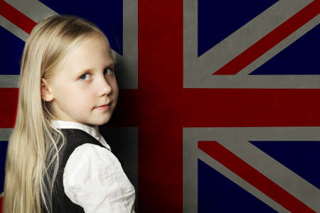 Cute child girl student against the UK flagの写真素材