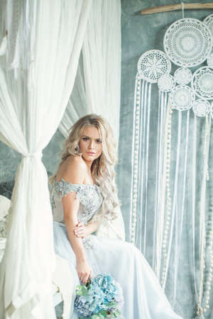 Pretty woman wearing blue tulle dress in romantic locationの写真素材