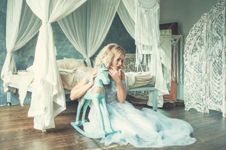 Perfect woman in tulle dress relaxing in romantic retro interiorの写真素材