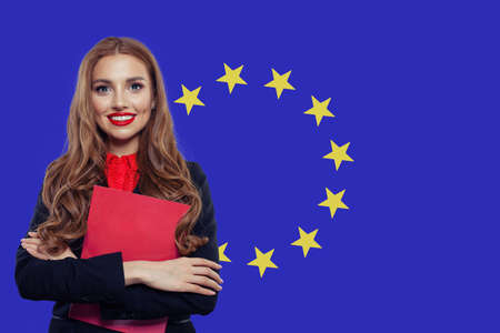 Happy woman student with book against the European Union flagの写真素材