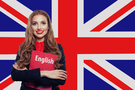 Happy woman against the UK flagの写真素材