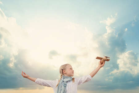 Traveling and freedom concept. Girl in White shirt and airplaneの写真素材