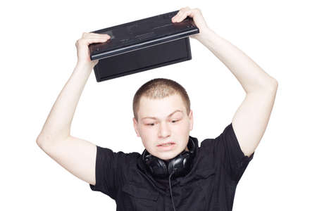 Nervous manager in black breaks a laptopの写真素材