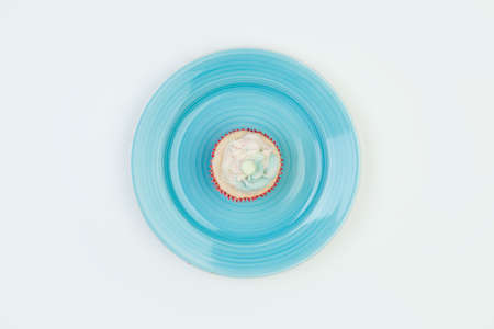Sweet cake on a blue plate, top view on a whiteの写真素材