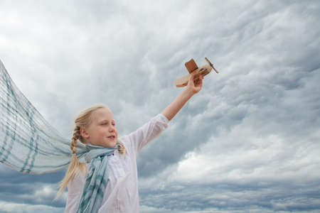 Traveling and freedom concept. Girl in White shirt and airplaneの写真素材