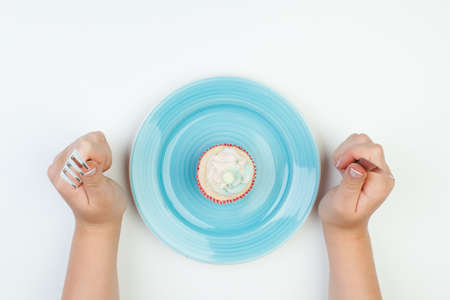 Sweet cake on a blue plate, top view on a white background. Copy space.の写真素材