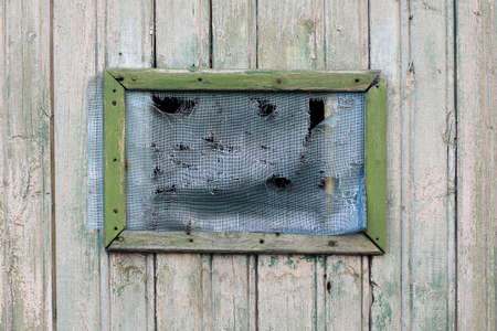 Old hole in Grid on the older wooden windowの写真素材