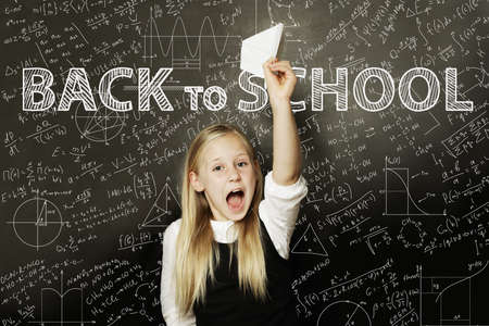 girl Student happy with plane on math chalkboard. Back to school background. Concept search ideasの写真素材