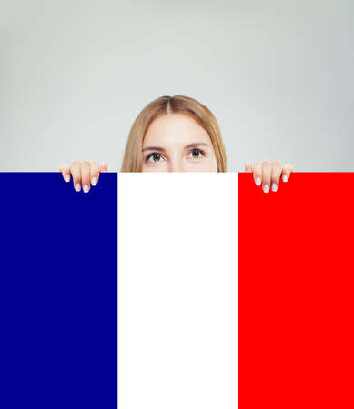France concept with happy woman showing French flag. Travel in France and study french languageの写真素材