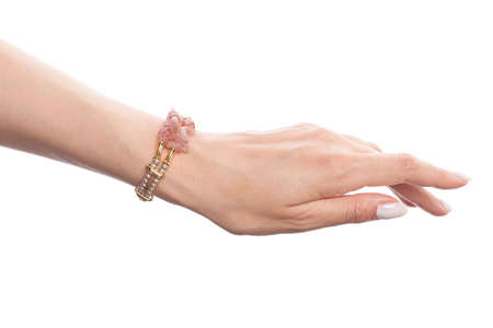 Woman jewelry. Hand in jewelry bracelet with pearls and opal isolated on white backgroundの写真素材
