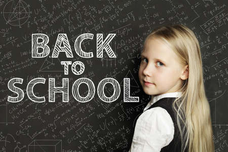 School girl and chalkboard with math formulas. Back to school backgroundの写真素材