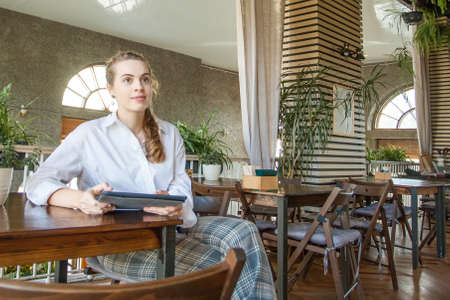 Thinking woman with laptop gadget planningの写真素材