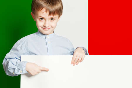Happy child boy holding white banner with Italian flagの写真素材