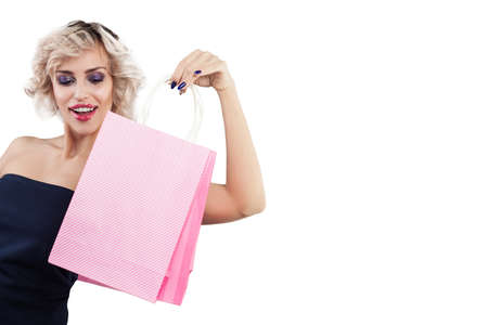 Beautiful surprised woman with shopping bags portrait on white backgroundの写真素材
