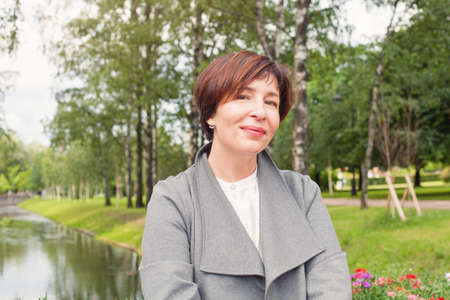 Elegant female model 45 years old. Pretty mature woman outdoorsの写真素材