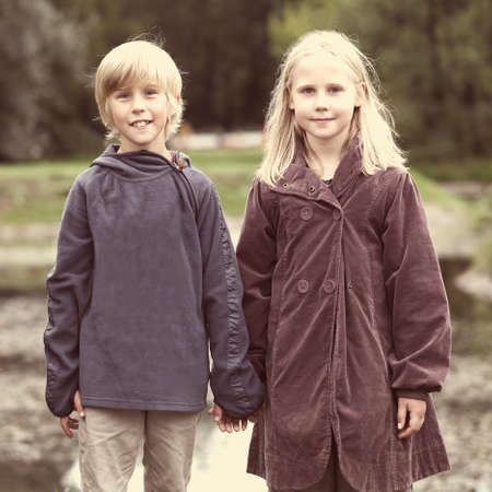 First love, romantic concept, little boy and girl holding handsの写真素材