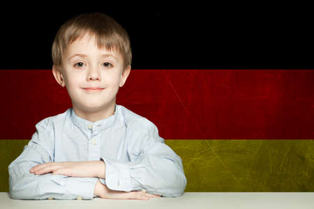 Thinking child boy student against the Germany flag background. Deutsch conceptの写真素材