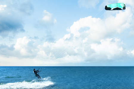 Kitesurfing riding over a surface of the Mediterranean sea with a parachute. Summer water sportの写真素材