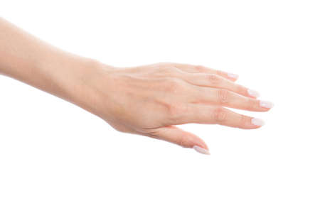 Female hand with white manicured nails isolated on white backgroundの写真素材