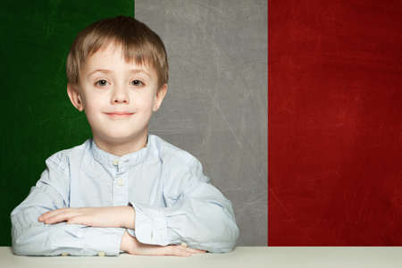 Thinking child boy student against the Italy flag background. Italian conceptの写真素材