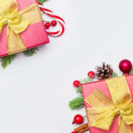Christmas red gift boxes with golden ribbon and bow on white background, flat lay top view with copy...