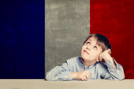 Learn french language concept. Happy child student with flag Franceの写真素材