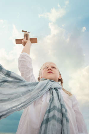 Traveling and freedom concept. Girl in White shirt and airplaneの写真素材