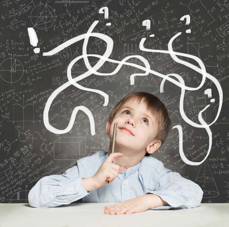 School Boy has an idea. Education Concept with question signsの写真素材