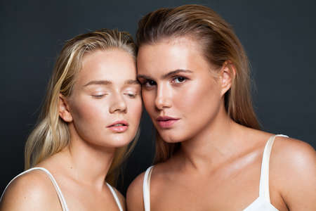 Female couple. Two pretty women with natural skin and blonde hair