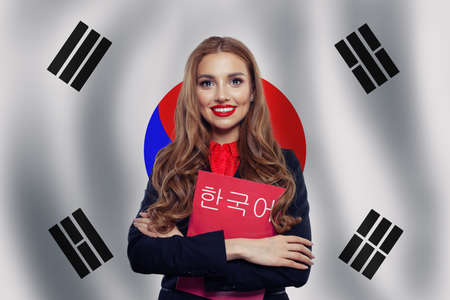 Study korean language. Happy cheerful woman student on the Republic of Korea flagの写真素材