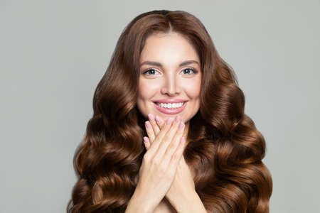 Beautiful woman with long healthy brown curly hair