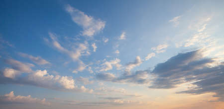 Blue sky clouds background. Beautiful landscape with clouds and orange sun on sky
の写真素材