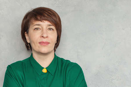 Confident woman with short haircut on grayの写真素材