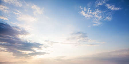 Blue sky clouds background. Beautiful landscape with clouds and orange sun on sky
の写真素材