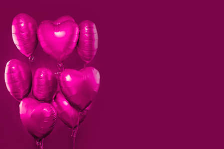 Pink heart balloons on bright pink card backgroundの写真素材