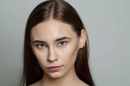Young beautiful woman without makeup cosmetics portrait. Face closeup, real skinの写真素材