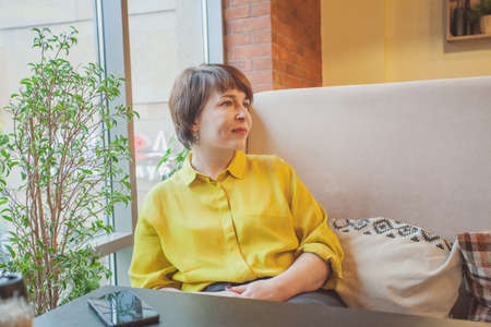 Mature woman resting in cafeの写真素材