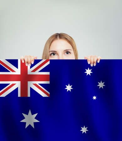 Travel and study in Australia concept with Pretty girl student with australian flag backgroundの写真素材