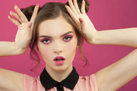 Perfect stylish woman with pink makeup on bright pink background