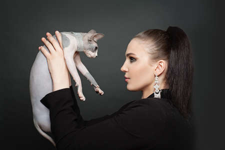 Elegant woman and cat in diamond on black backgroundの写真素材