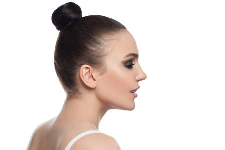 Beautiful woman face profile. Pretty model girl isolated on white backgroundの写真素材