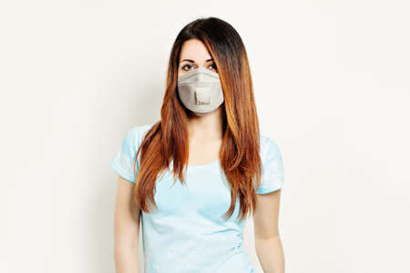 Pretty woman in protective mask on white backgroundの写真素材