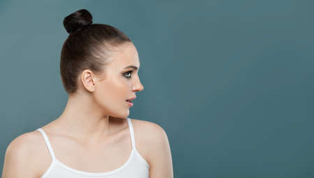 Healthy woman with clear healthy skin on blue, portrait