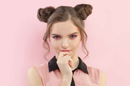 Young fashion model woman with pink makeup on pastel background