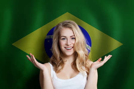Surprised happy woman with the Brazil flag backgroundの写真素材