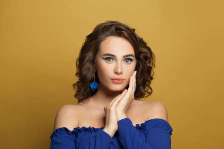 Cute fashion model woman on yellow backgroundの写真素材