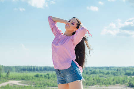Pretty young woman having fun and smiling outdoorの写真素材