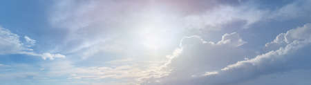 White clouds and morning sun on blue sky panoramic background