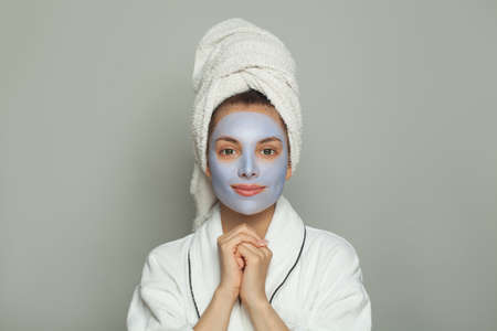 Cute spa woman in cosmetic face mask portrait. Facial treatment and skin care conceptの写真素材